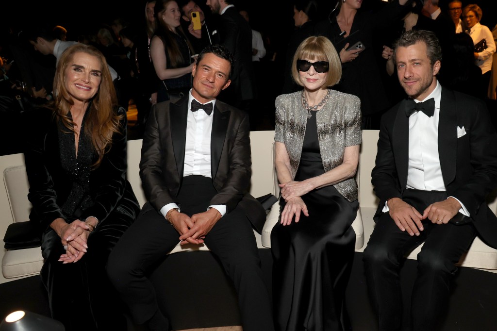 Brooke Shields, Orlando Bloom, Anna Wintour, and Francesco Carrozzini at a fashion show.