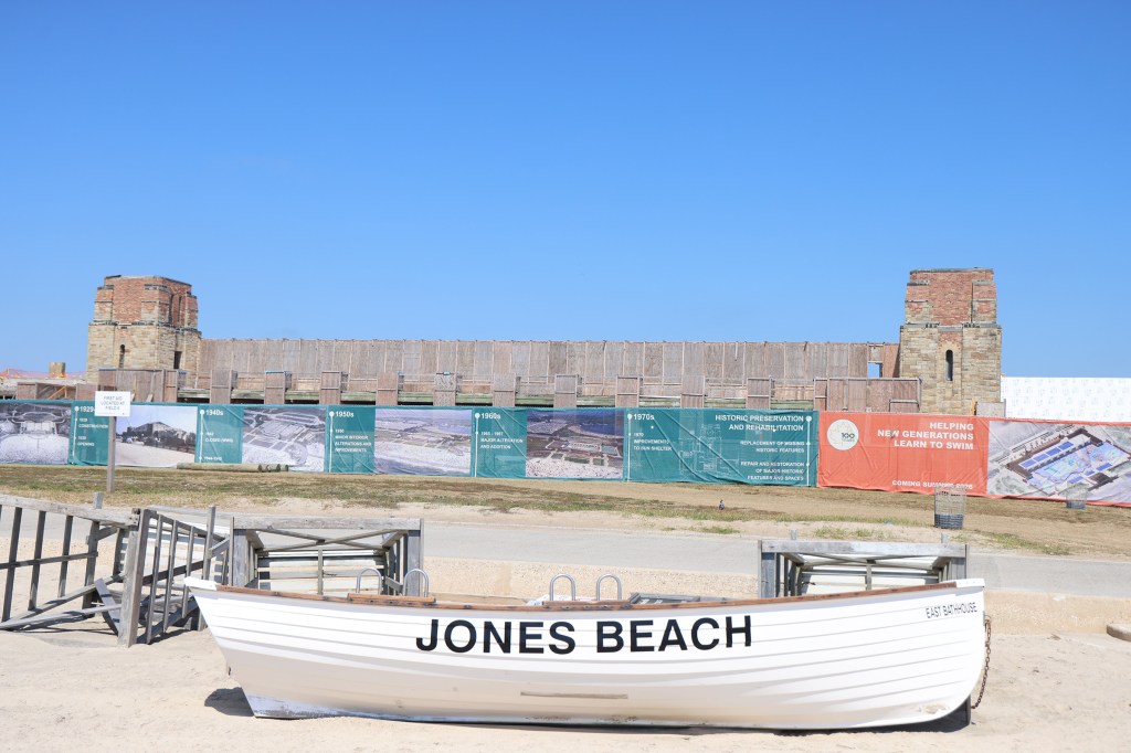 boat with jones beach written on the side with the beach behind it