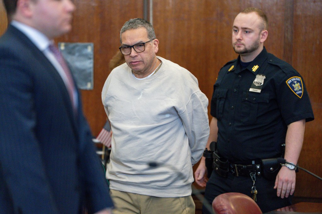 espinoza in grey sweatshirt and khakis with his arms behind him during a court appearance