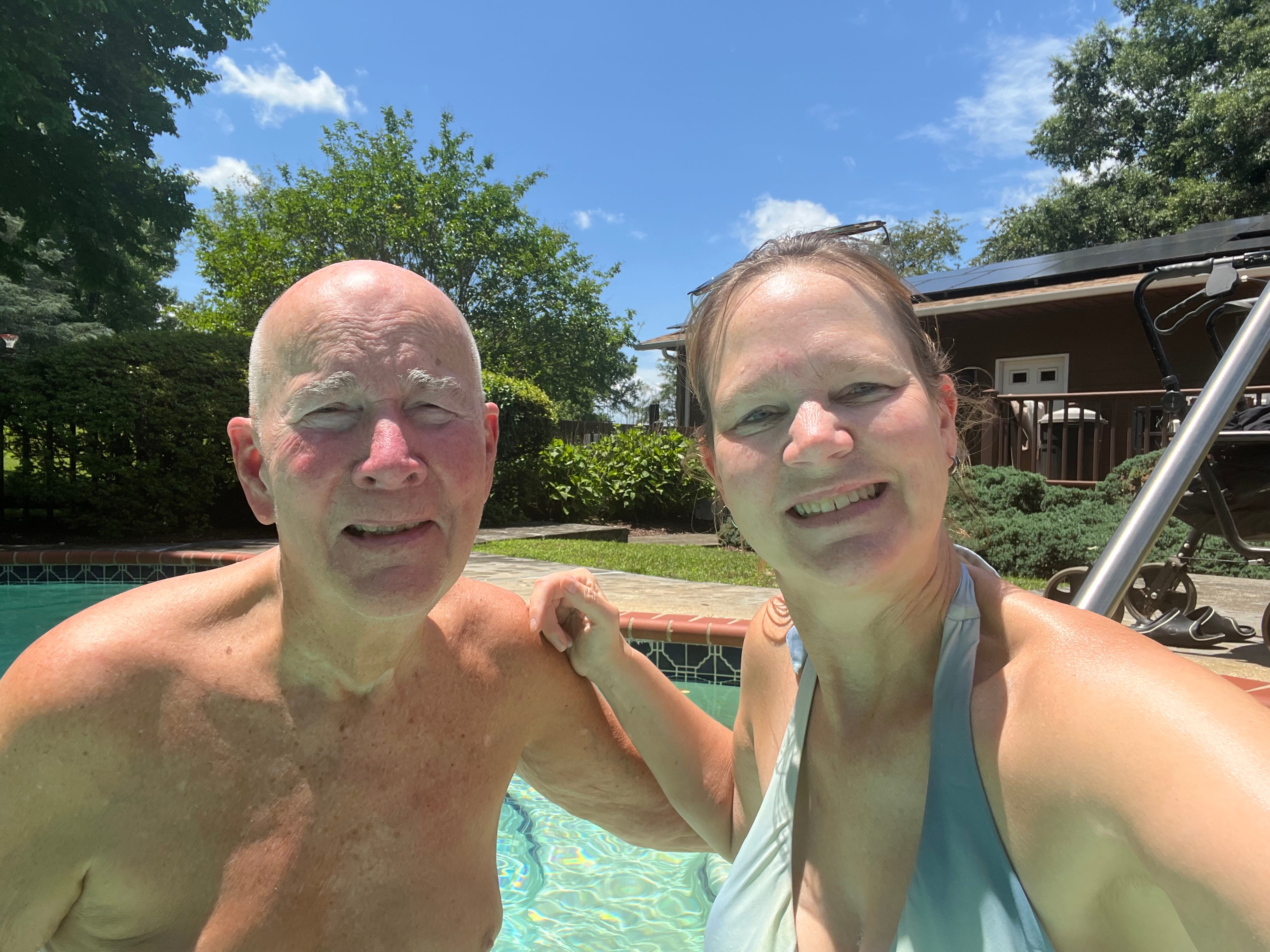 The author poses with her dad in a pool.