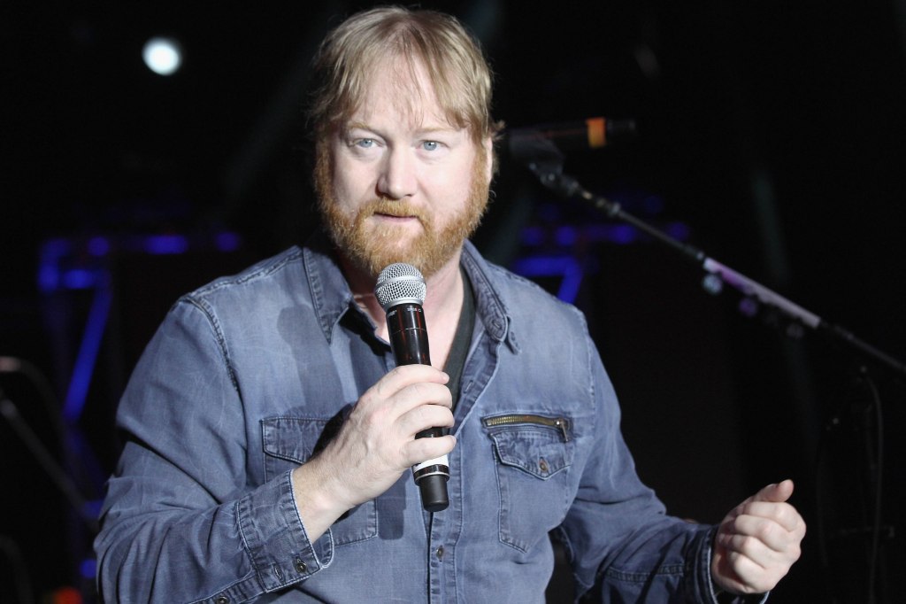 Jon Reep performing onstage with a microphone.