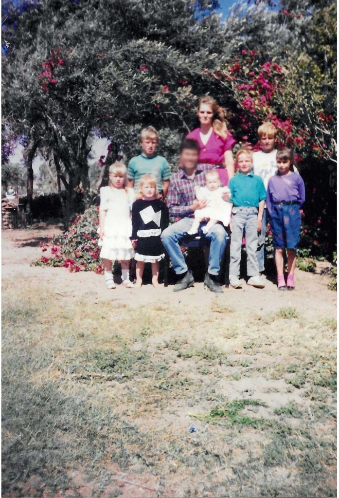 Photo of Pamela with her husband and seven children.