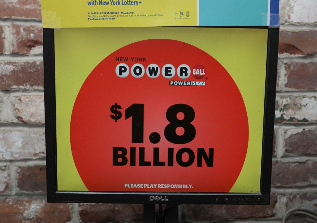 A Powerball sign touts the jaw-dropping $1.8 billion jackpot, the second-largest in U.S. history.