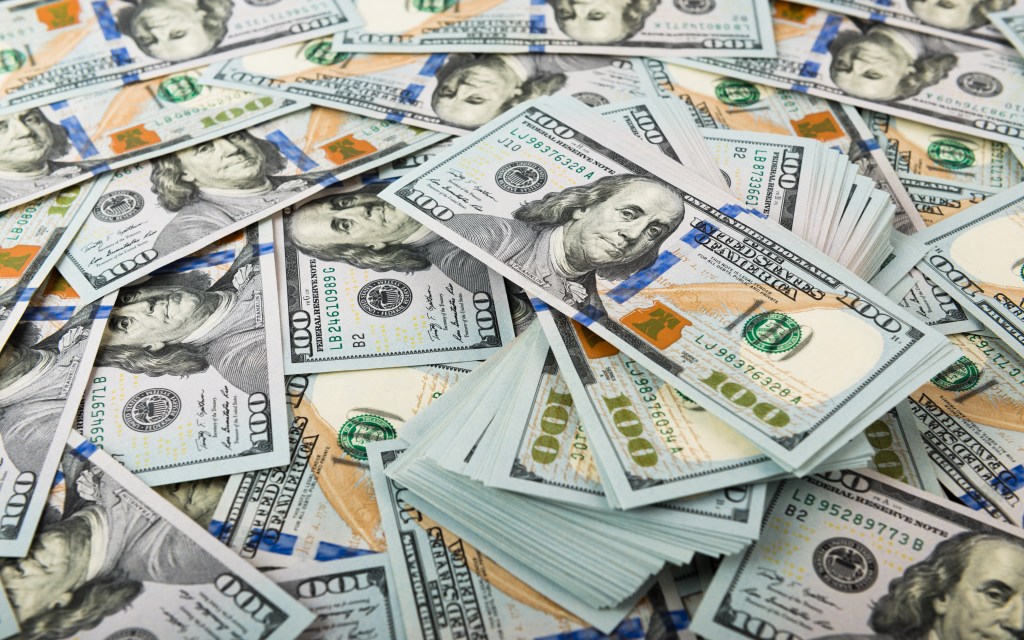 Stacks of $100 bills illustrate the life-changing fortune awaiting the jackpot winners.
