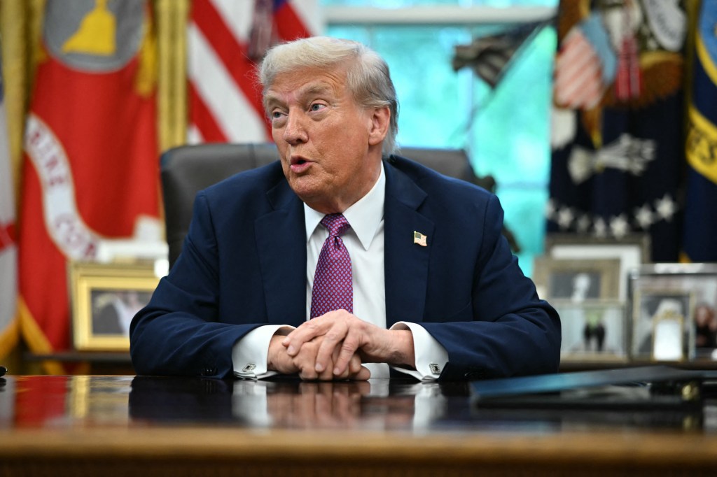 President Trump speaking at a desk in the Oval Office.