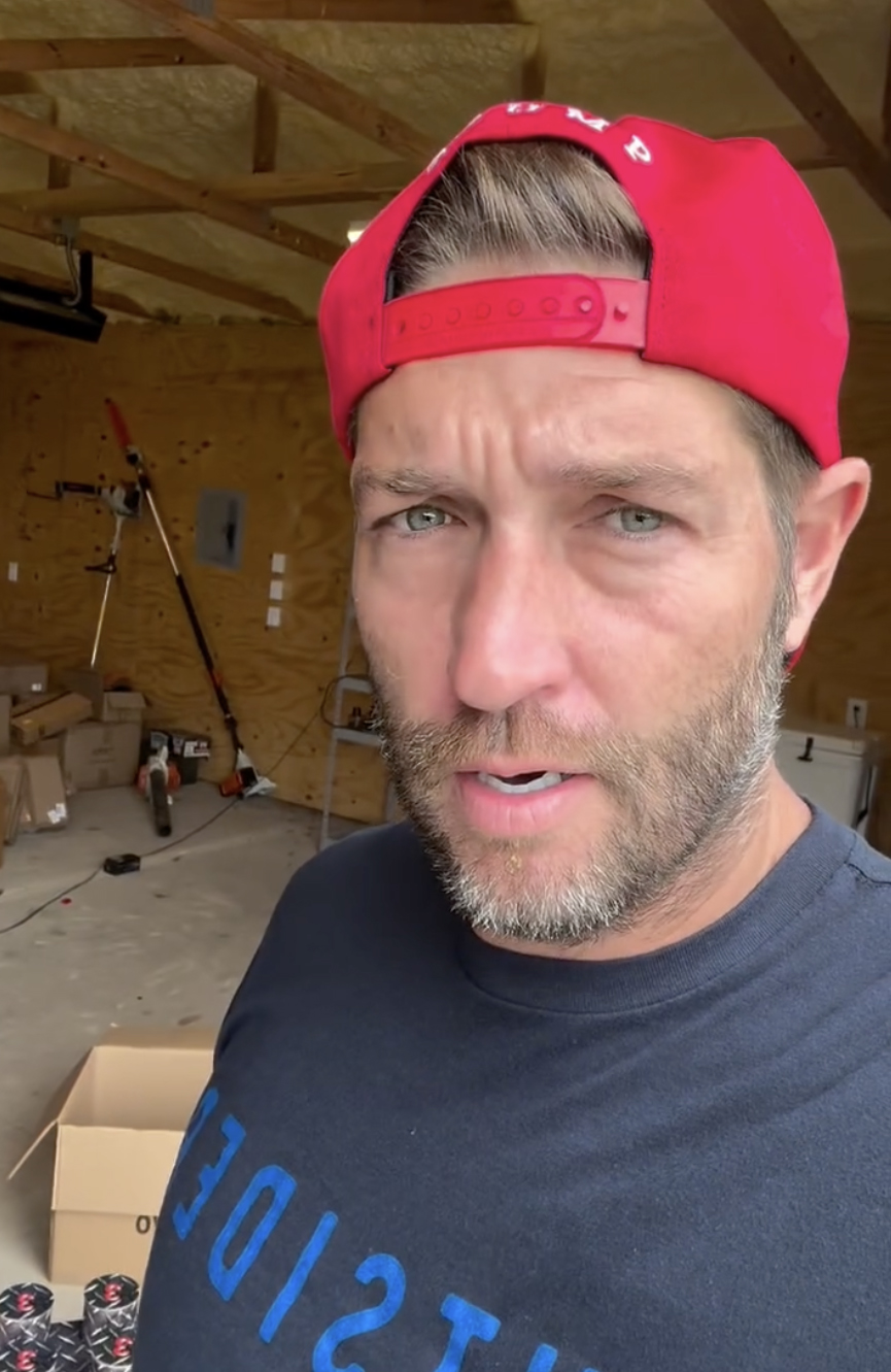 Jay Cutler in a red hat and blue shirt