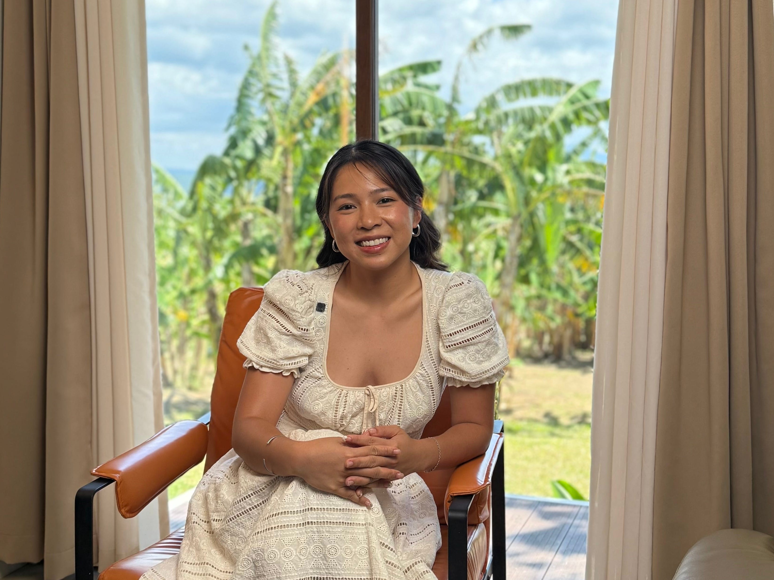 A woman sitting in a chair.