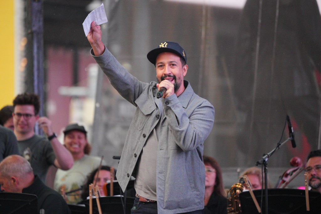 Lin-Manuel Miranda speaking at a Times Square concert.
