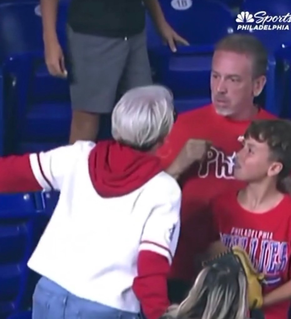 A Phillies fan aggressively confronts a father and son about a home run ball.