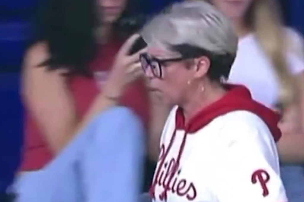 A Phillies fan taking a home run ball from her father.