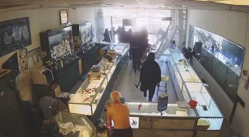 The robbers -- most seen armed with axes and hammers -- then start bashing in the display cases of the jewelry store and snatching gold and jewelry.