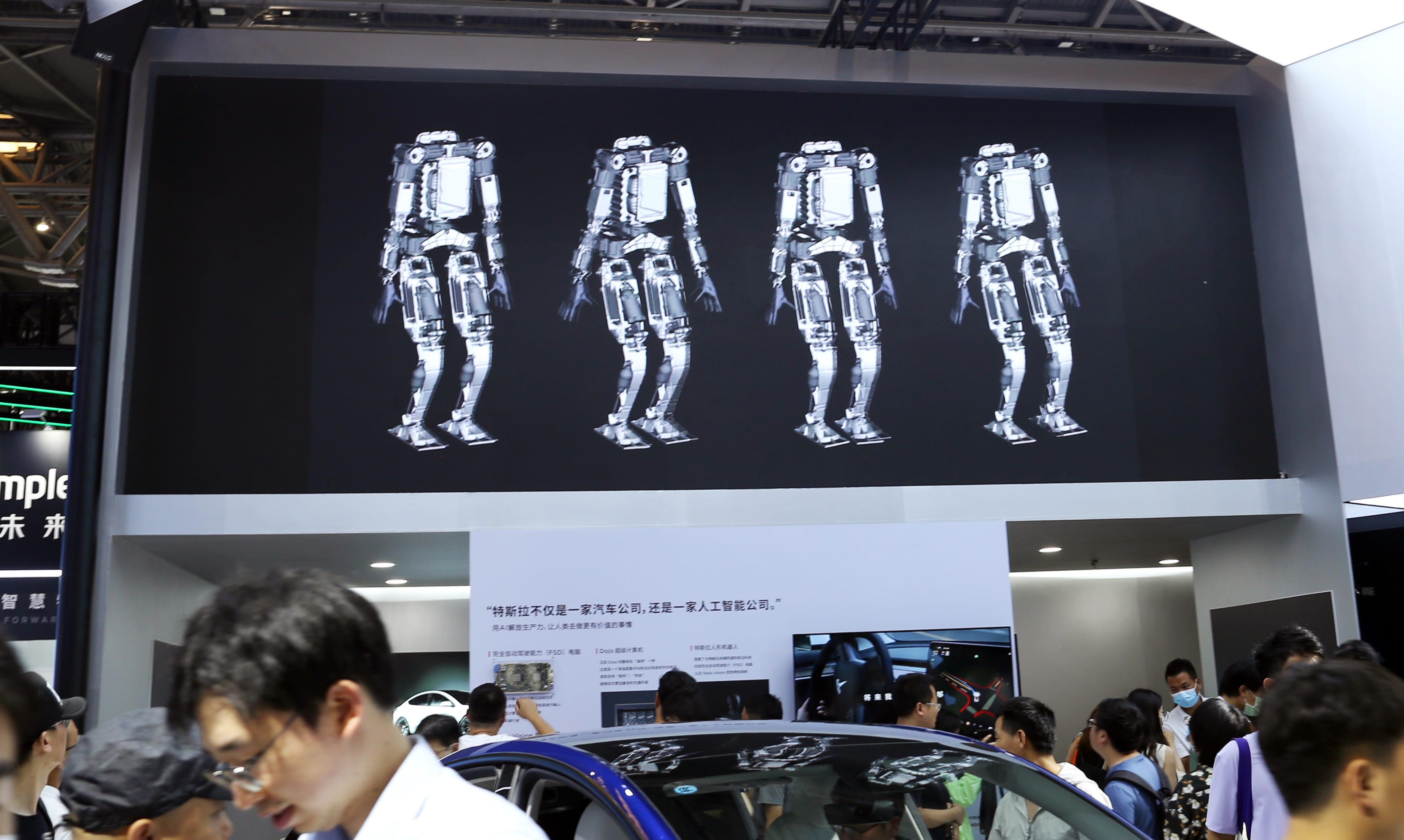 Images of Tesla's Optimus robot on screen at the 2023 WAIC in China.