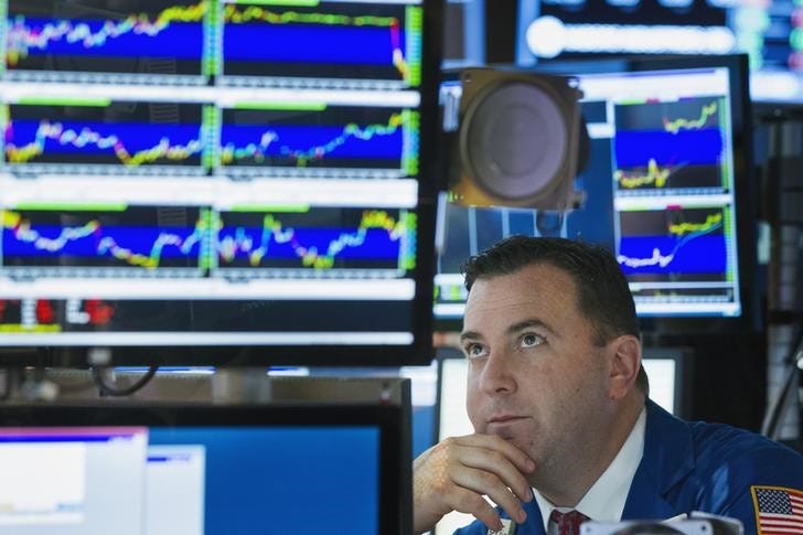 A trader looks up at his screen as he works on the floor of the New York Stock Exchange shortly before the closing of the market in New York, July 11, 2013. REUTERS/Lucas Jackson