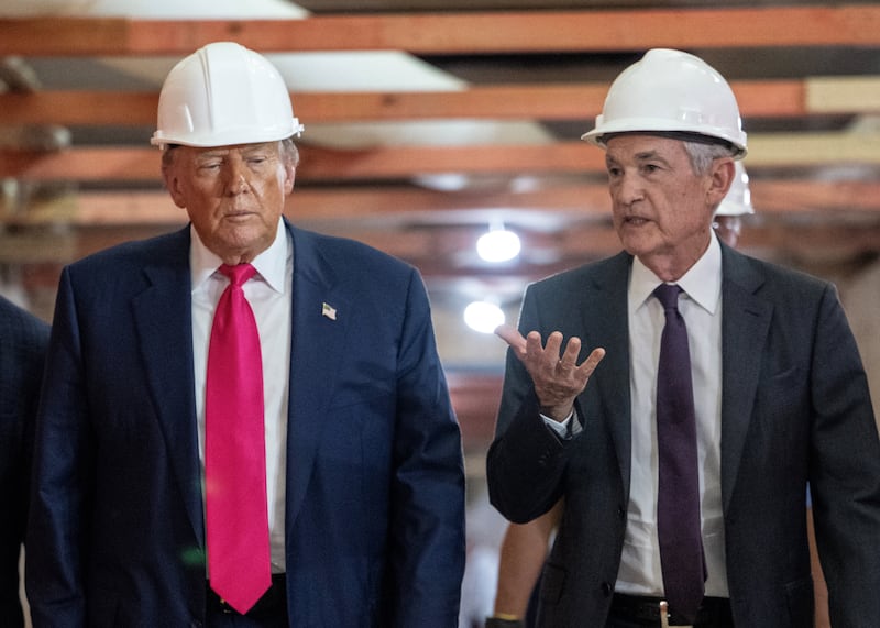 President Donald Trump speaks with Federal Reserve chair Jerome Powell (R) as he visits the Federal Reserve in Washington, DC, on July 24, 2025.