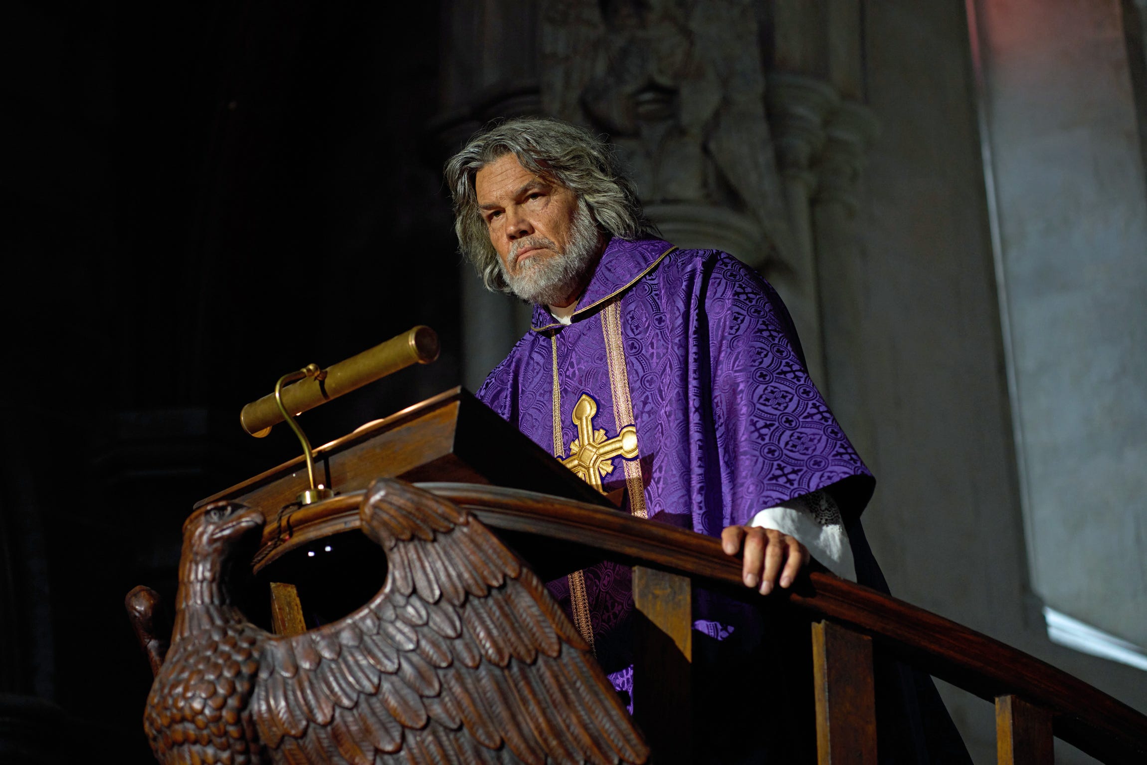 Josh Brolin dressed as a priest in the movie Wake Up Dead Man