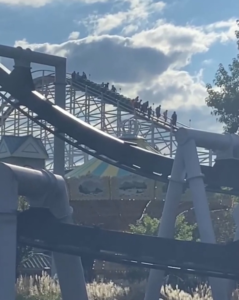 People boarding a roller coaster.