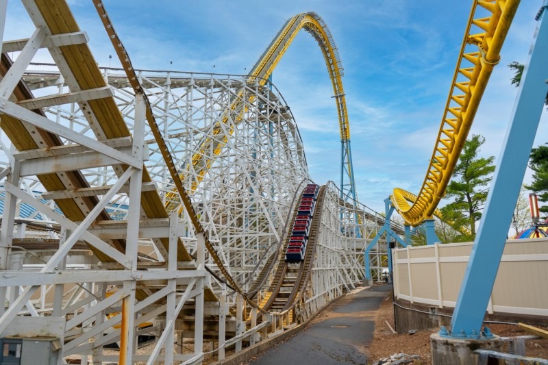 Roller coaster with a train ascending a lift hill.