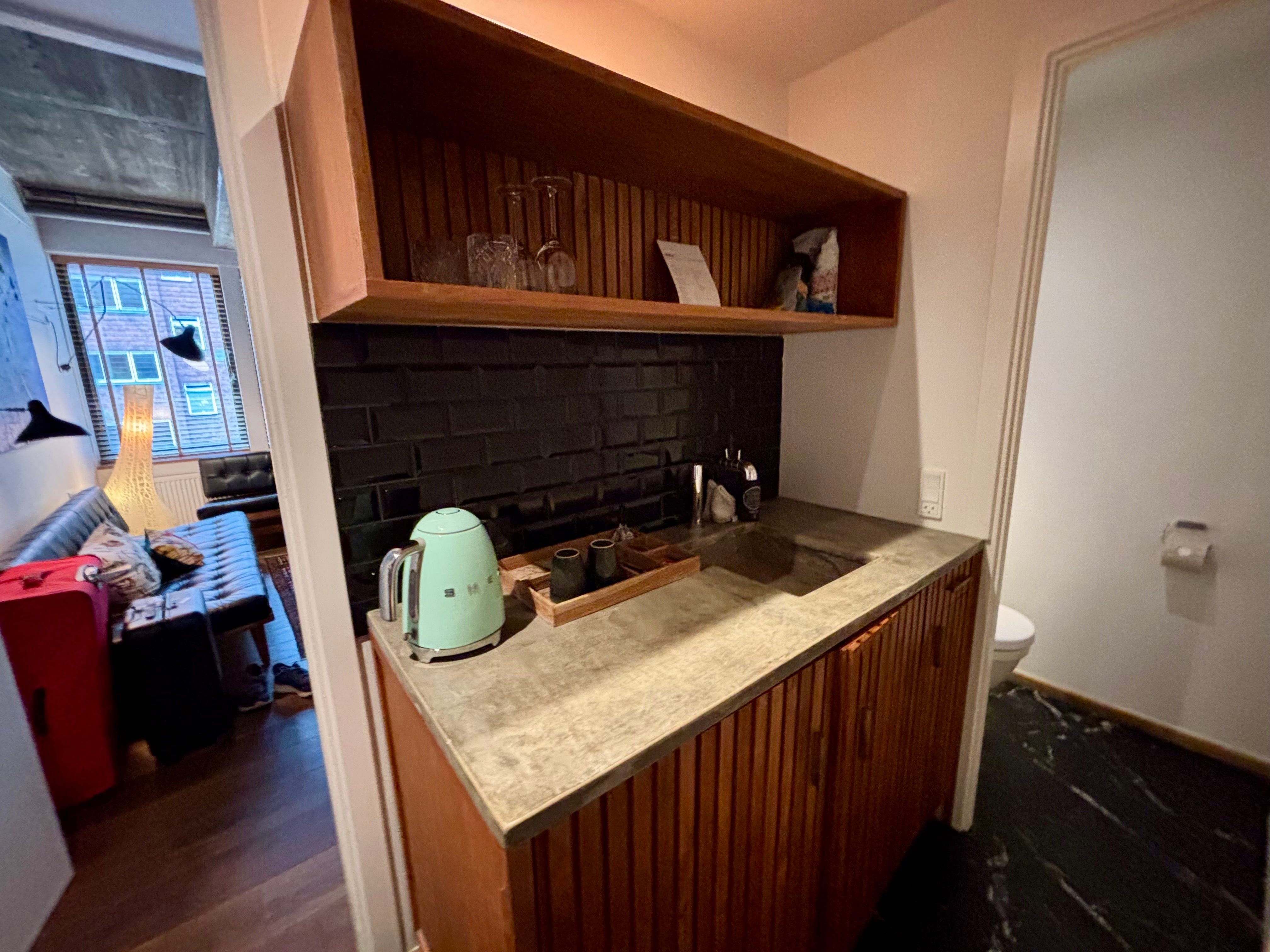 A kitchen area of a hotel suite.