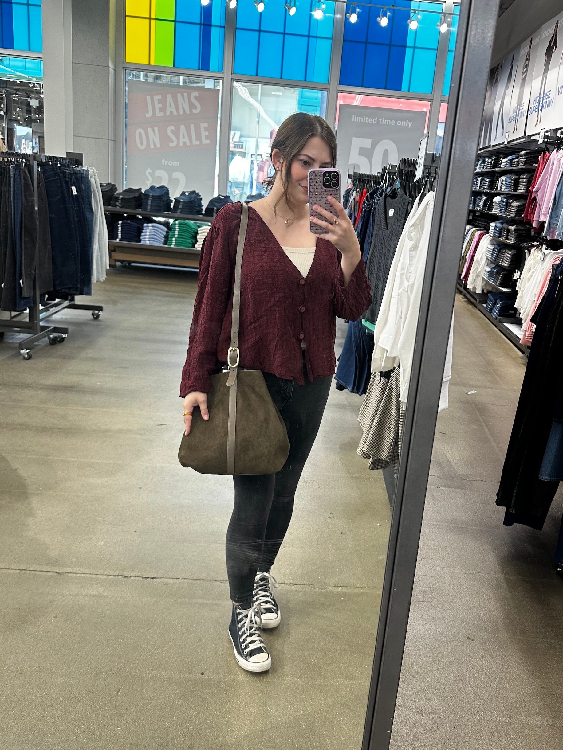 Reporter Amanda Krause tests a suede bag at Old Navy.