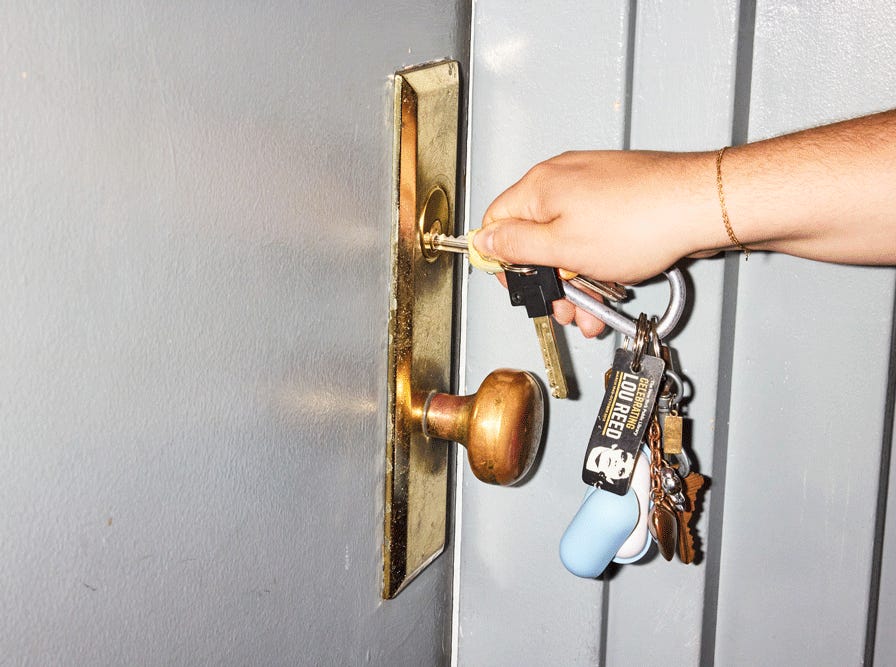 A key opening a door.