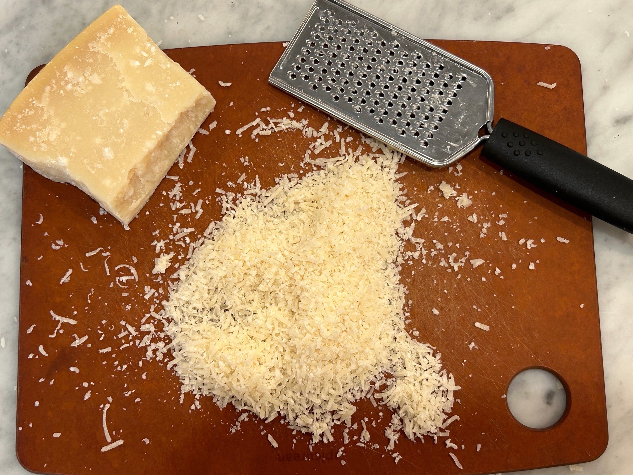 Grating cheese for Gordon Ramsay's cacio e pepe
