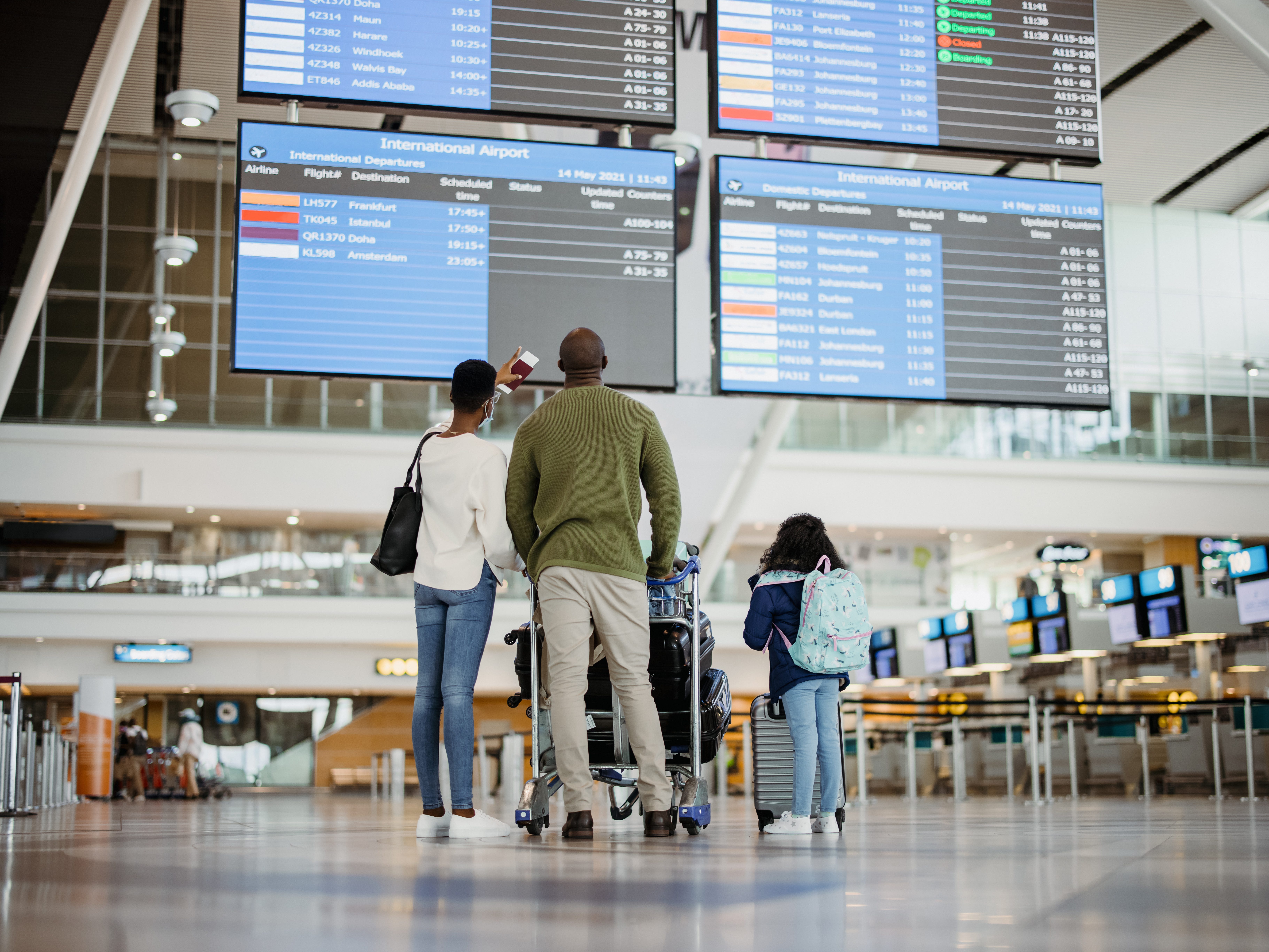 A family at an international airport terminal.