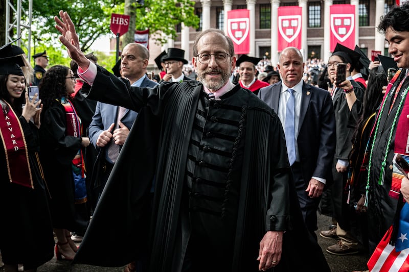 Alan Garber interacts with students during commencement ceremony at Harvard University