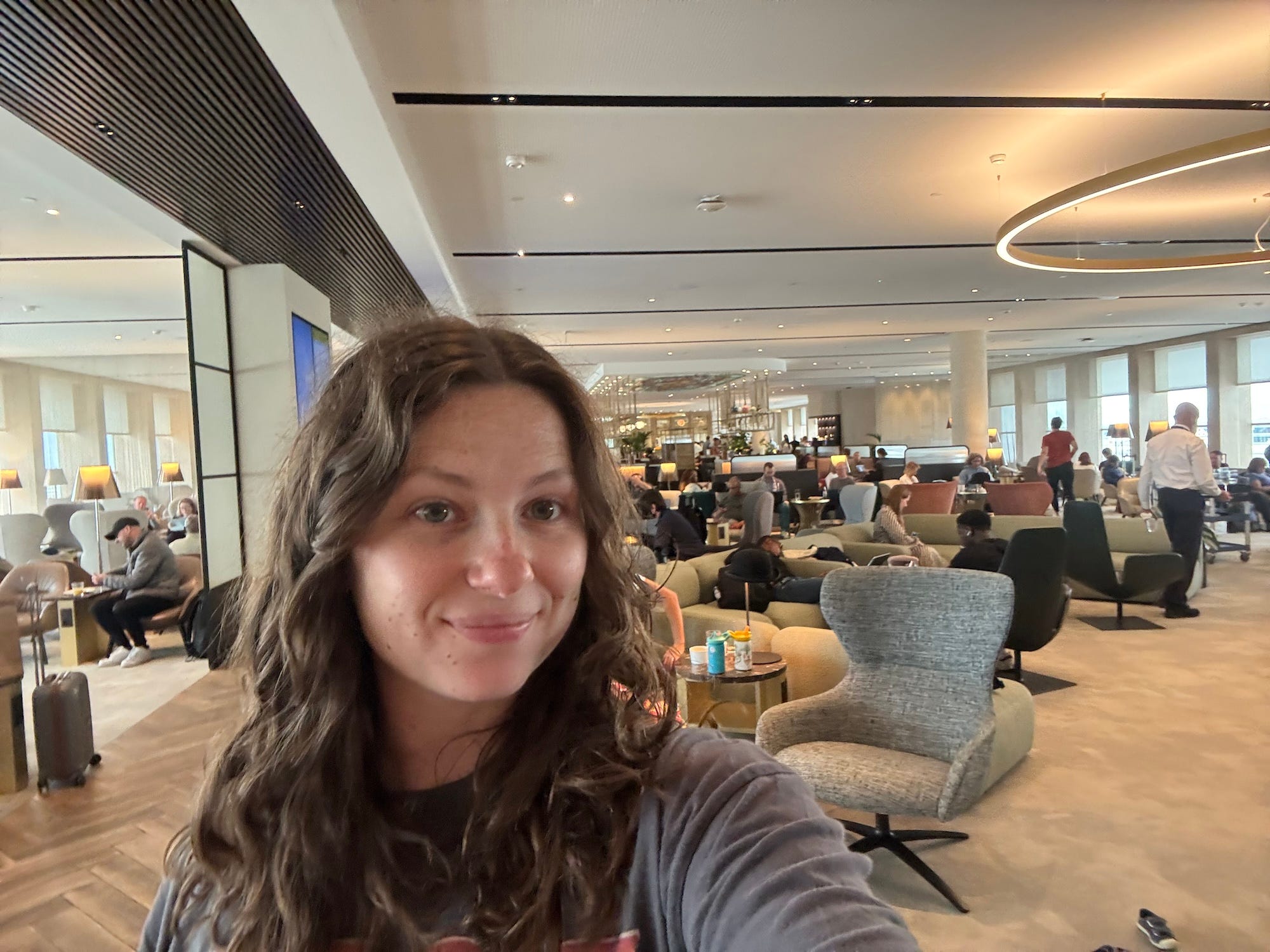 A selfie of a woman in an airport lounge.