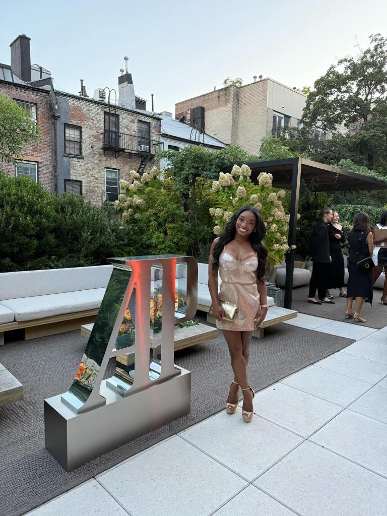 Simone Biles is all smiles in a glittering mini dress.