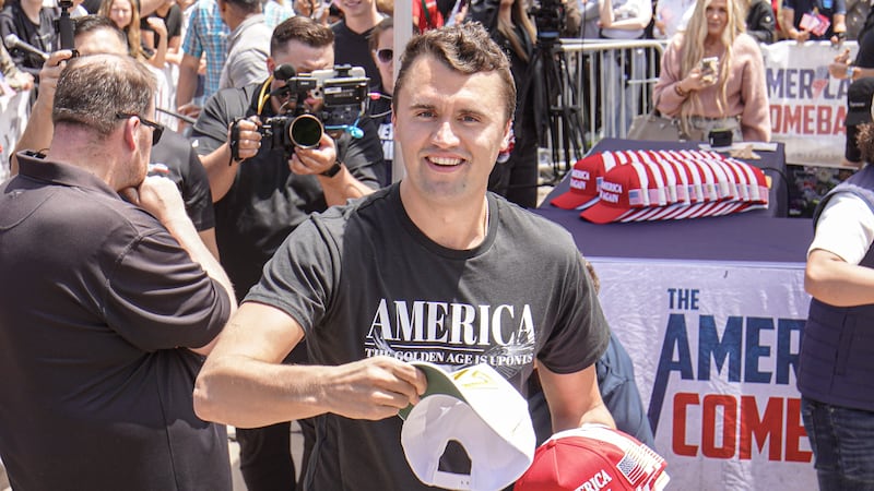 SAN DIEGO, CALIFORNIA, UNITED STATES - 2025/05/01: Charlie Kirk, founder of Turning Point USA, throws hats to the public. Turning Point USA founder and American conservative political activist, Charlie Kirk sets up in UC San Diego's Town Square fielding rapid-fire questions from students and community members in a signature 