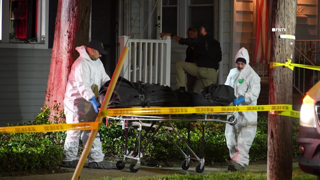 Investigators removing bodies from a crime scene.