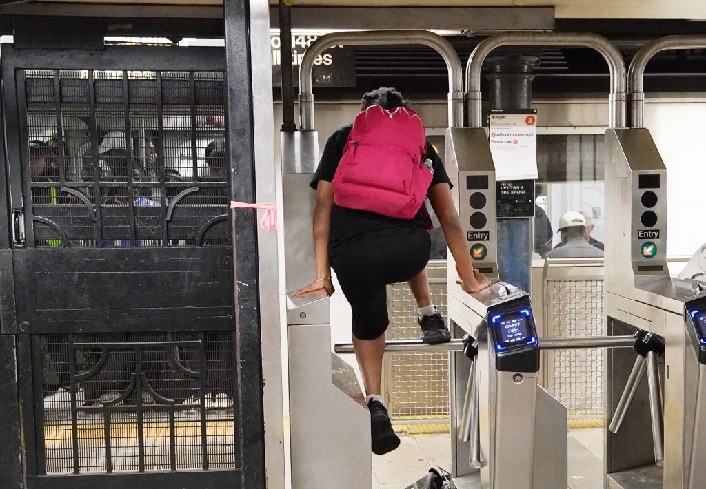 A general view of a person jumping over the subway turnstile or stepping over the subway turnstile at the Lenox Avenue and 125th Street subway station in New York, NY on August 30, 2025. 
