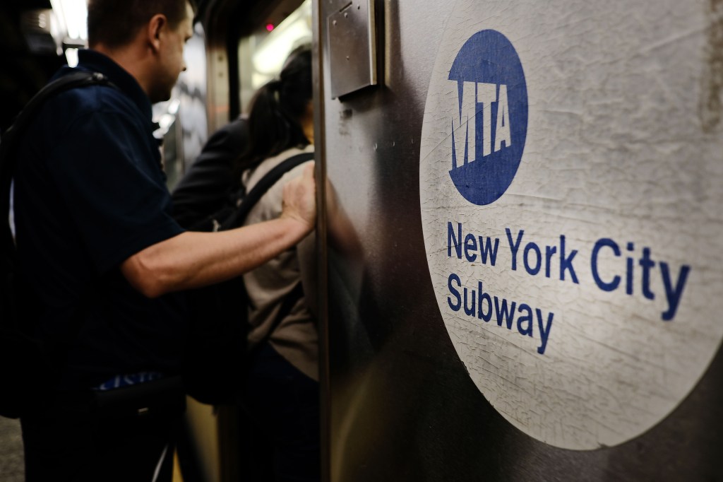 Passengers enter a Metropolitan Transportation Authority (MTA) subway on June 29, 2017.