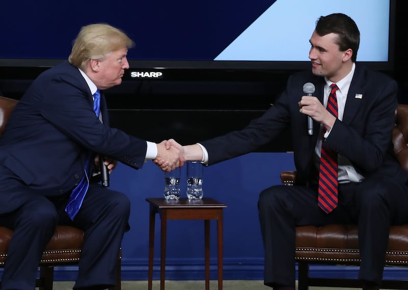President Donald Trump shakes hands with conservative activist Charlie Kirk at a forum dubbed the Generation Next Summit at the White House on March 22, 2018 in Washington, DC.