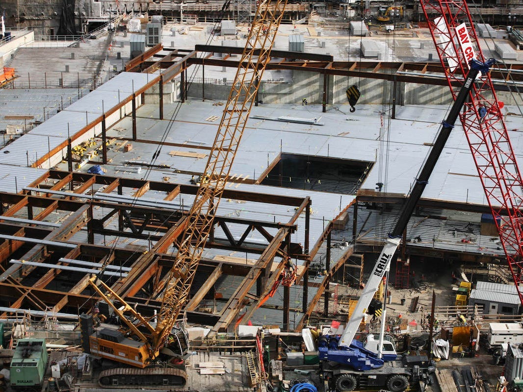 Cranes work above the north pool of the National September 11 Memorial and Museum at the World Trade Center site Tuesday, Jan. 27, 2009 in New York.