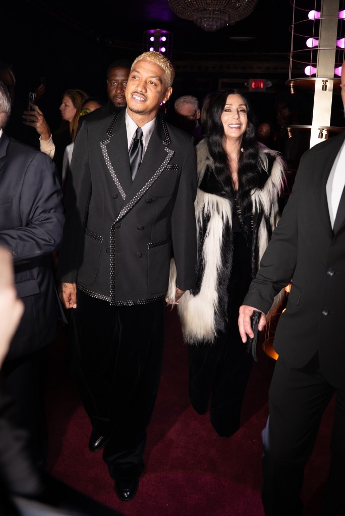 Cher and Alexander Edwards hold hands while arriving at the Valentino Beauty Event in NYC.