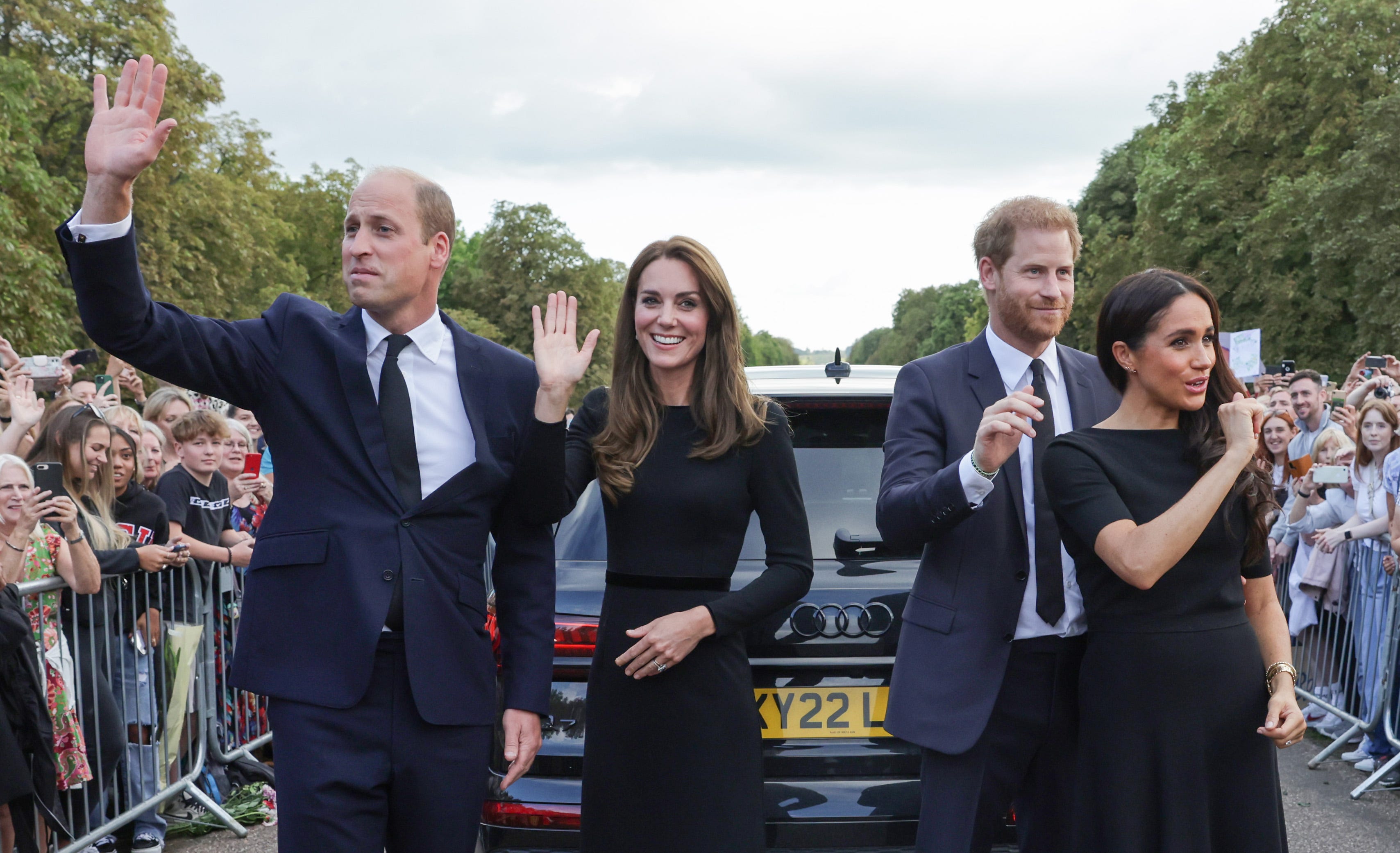 Prince William, Princess Kate, Prince Harry, and Meghan Markle wave as they walk around Windsor Castle