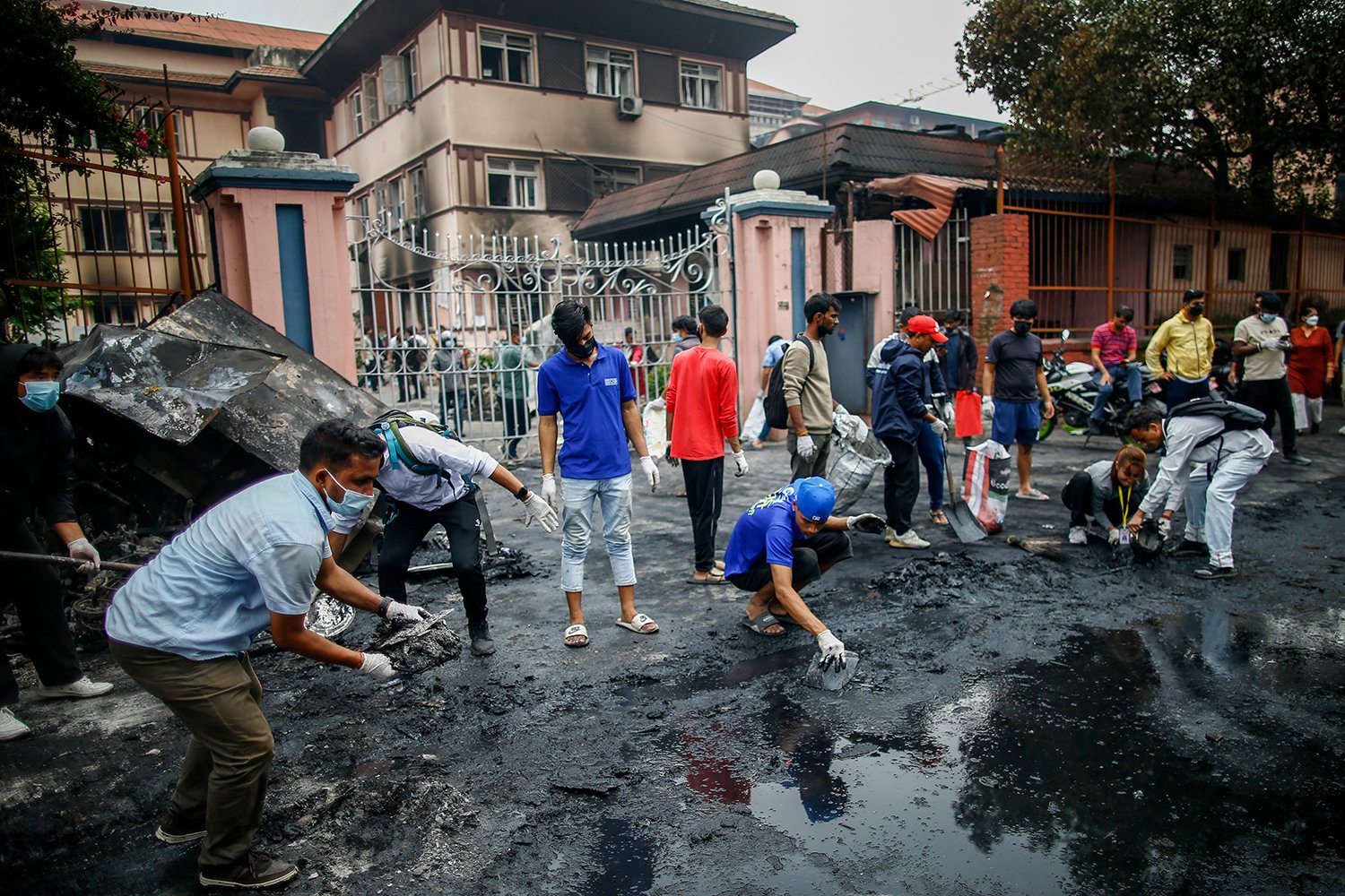 Young people clean up the streets outside the Supreme Court following the so-called Gen Z protests in Kathmandu, Nepal, on Sept. 10. The demonstrations, which erupted this week and were fueled by a social media ban and anger over corruption, forced Prime Minister K.P. Sharma Oli to resign. More than 30 were killed, and the country remains under martial law.