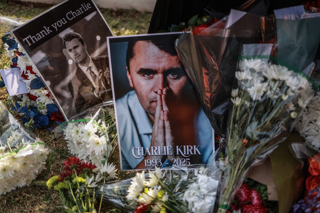 Memorial of Charlie Kirk with flowers and photos.