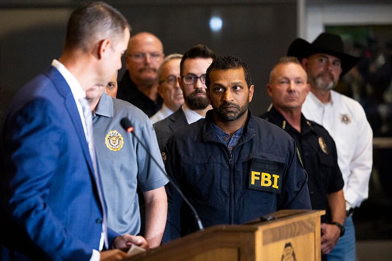 FBI director Kash Patel listens as Utah Department of Public Safety commissioner Beau Mason, left, speaks during a press conference at Utah Valley University on September 11, 2025 in Orem, Utah. Authorities have released a "person of interest" as they search for the suspect who shot and killed Kirk, founder of Turning Point USA, while he was speaking at an event for his "American Comeback Tour". (Photo by Michael Ciaglo/Getty Images)