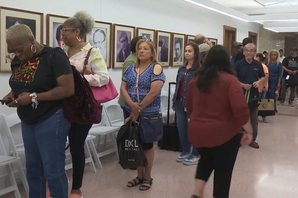 Outraged Houston residents wait in line outside the city board meeting to discuss their pensions.