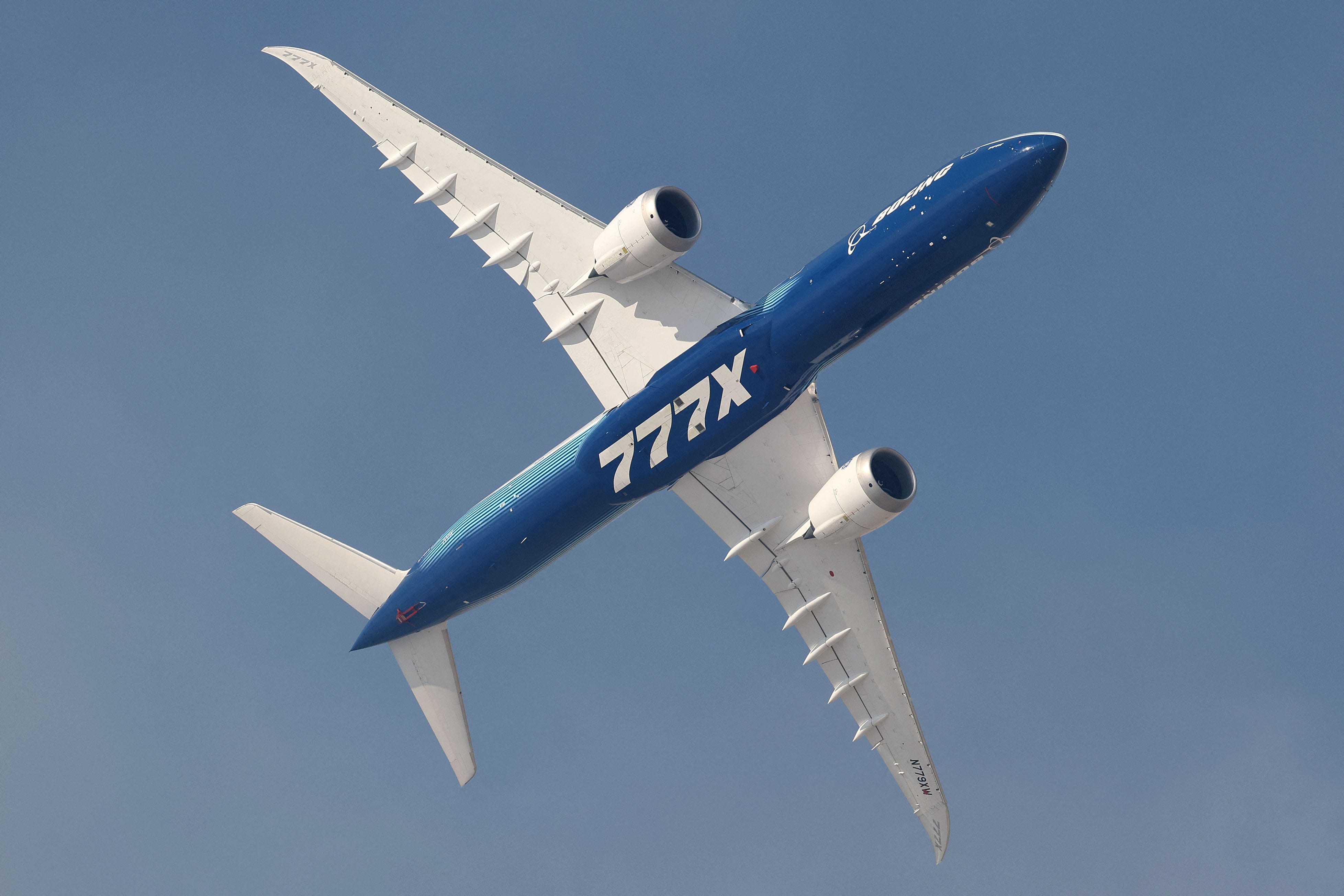 A Boeing 777-X aircraft flies during the 2023 Dubai Airshow at Dubai World Central - Al-Maktoum International Airport in Dubai on November 13, 2023.