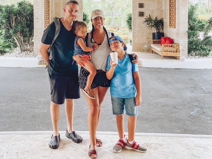 Author Giana Vasconcellos, husband, two kids at resort entrance