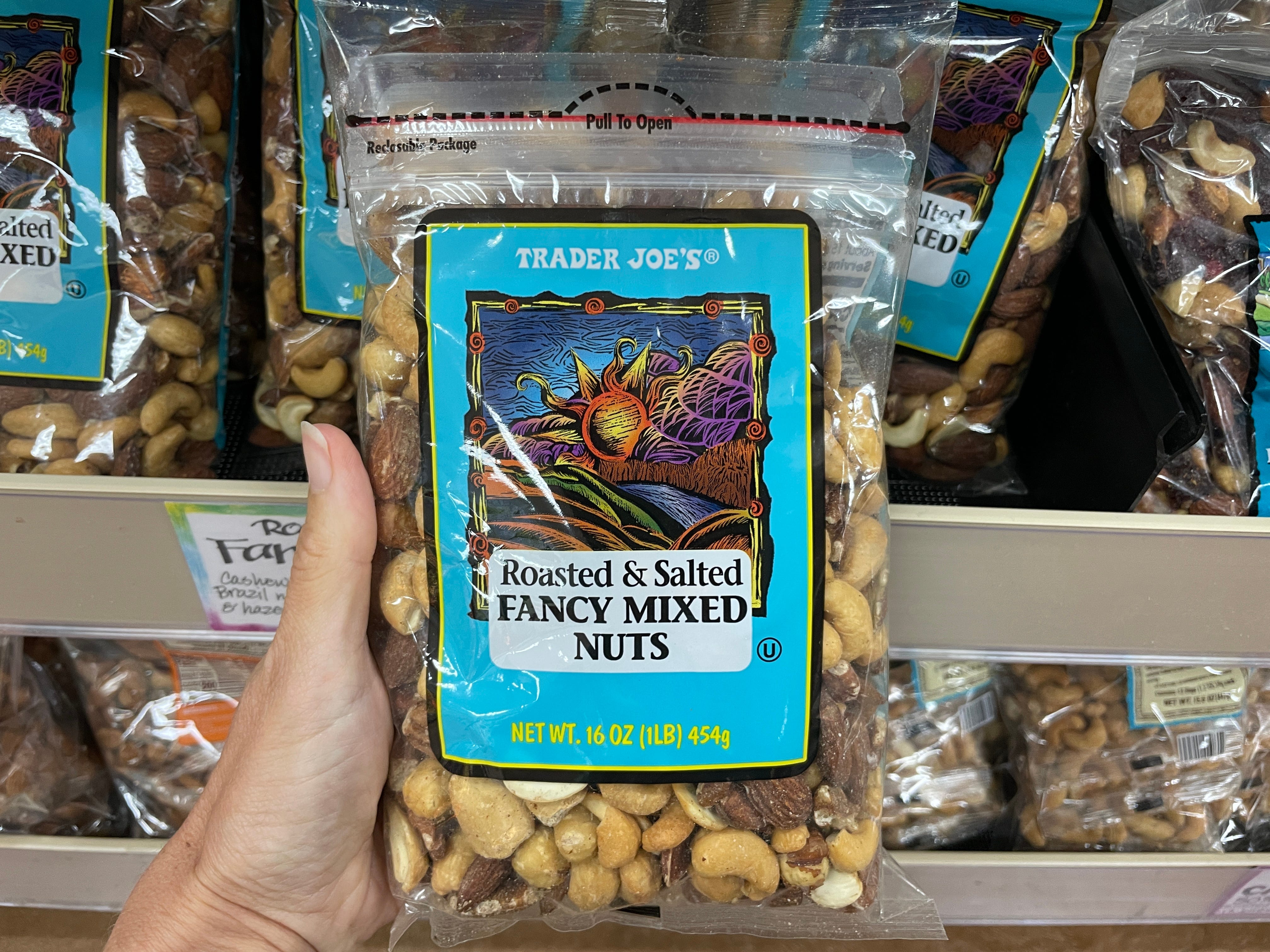 Hand holding Trader Joe's fancy mixed nuts
