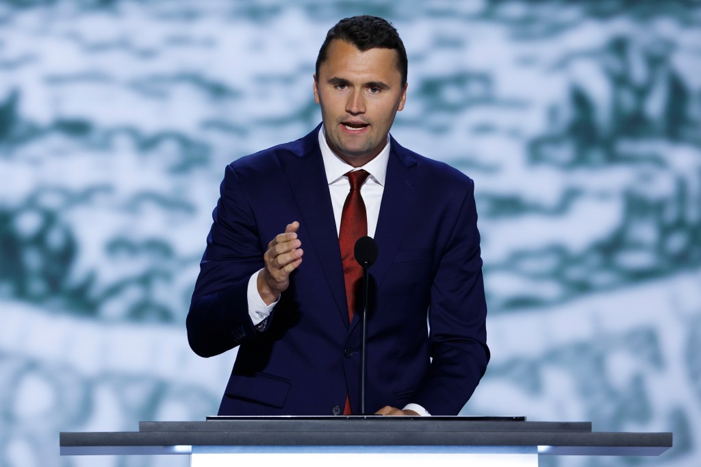 Charlie Kirk speaking at a podium.