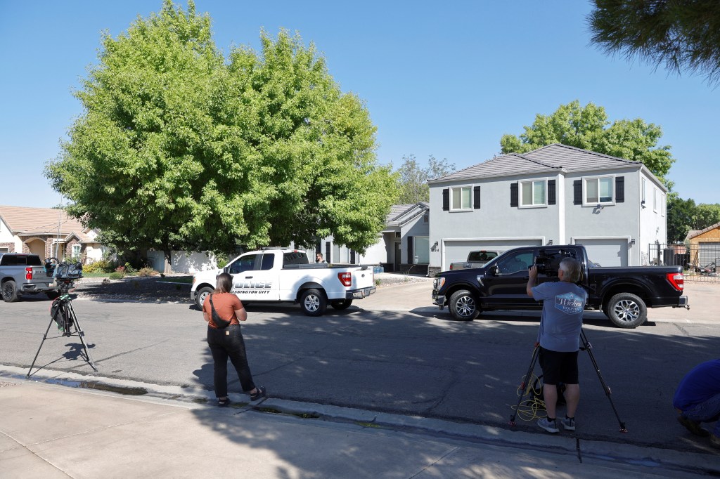 Law enforcement and media at a Washington residence.