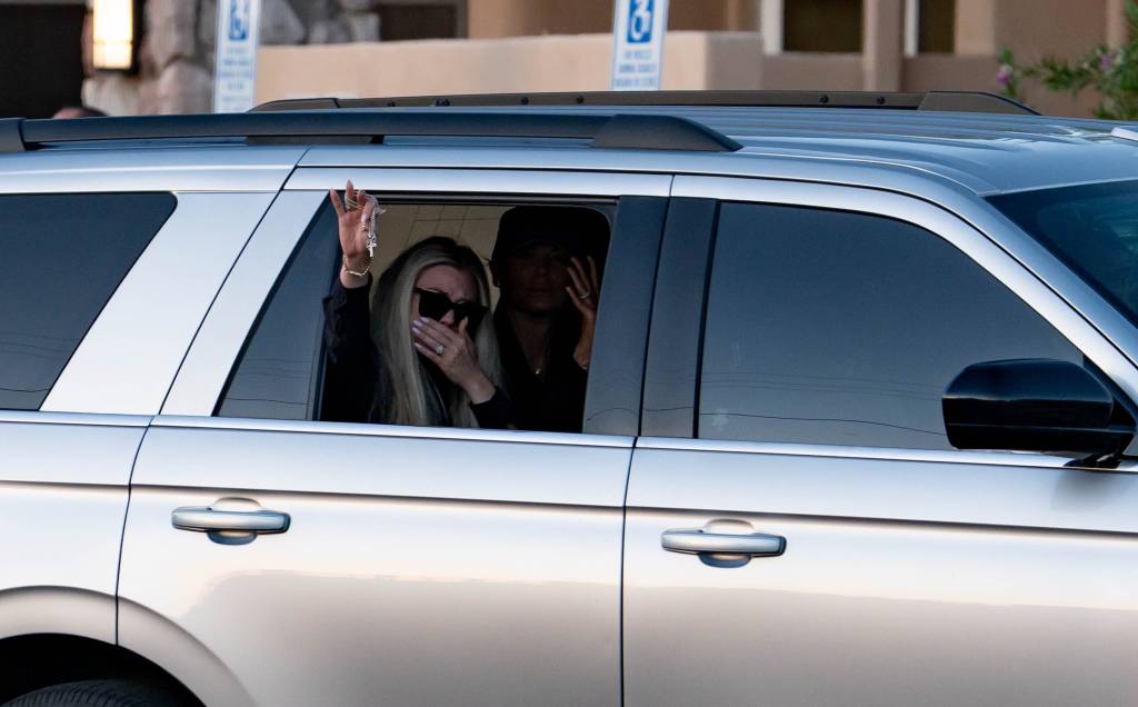 Erika Kirk waves to supporters who gathered to watch as a motorcade escorted the body of Charlie Kirk to Hansen Mortuary Chapel in Phoenix on Sept. 11, 2025.