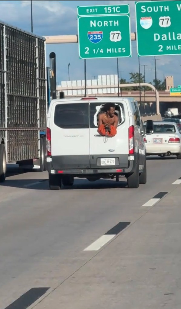 An unidentified inmate busted-out window on the rear of the prison transport vehicle down a Oklahoma freeway on Sept. 2.