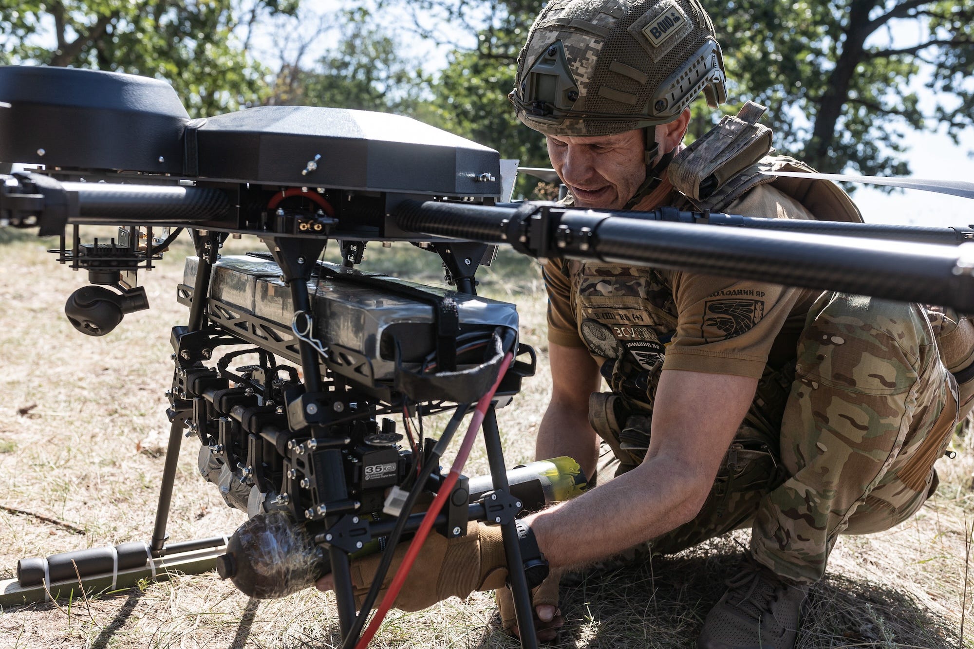 A Ukrainian soldier loads ammunition onto a drone at a training in September.