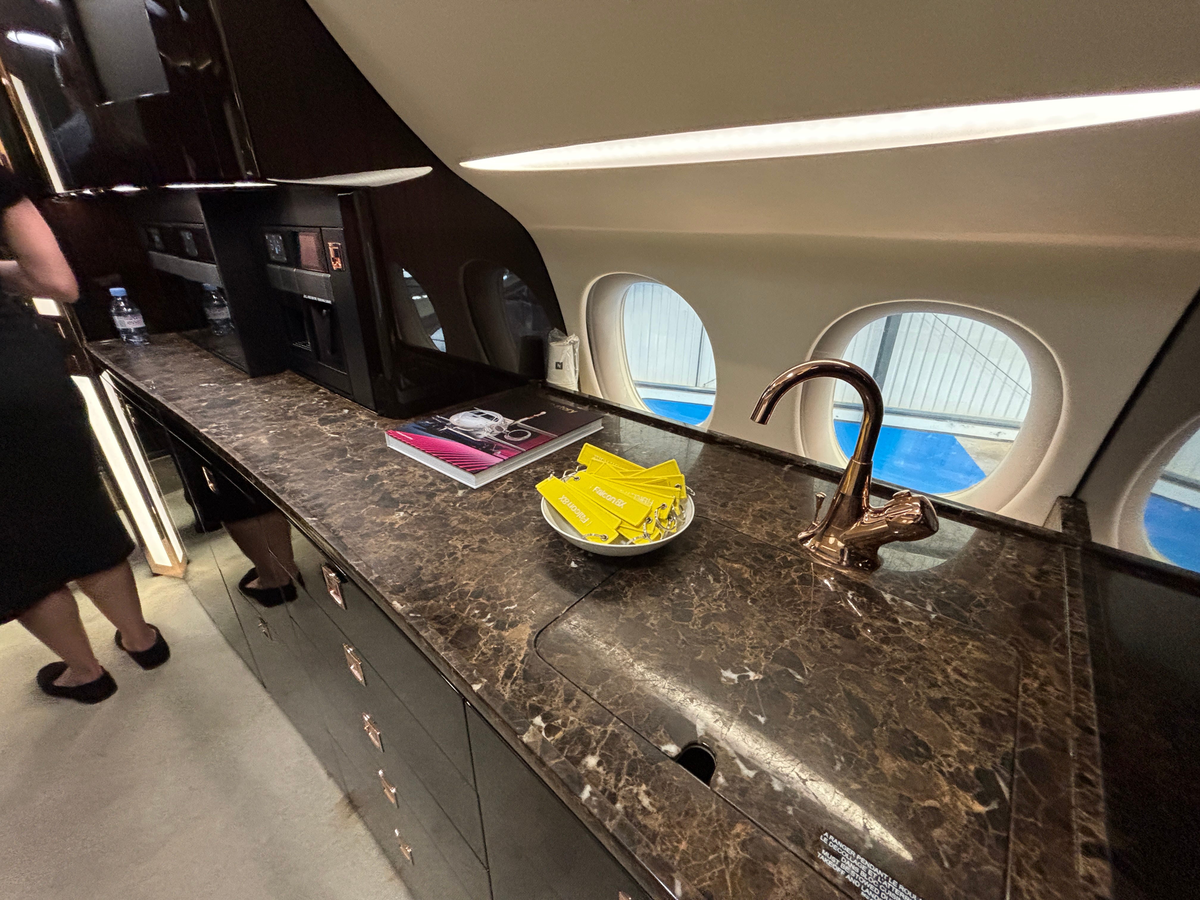 The galley with a marble countertop and sink on board a Dassault Falcon 8X on display at the 2025 Air Charter Expo
